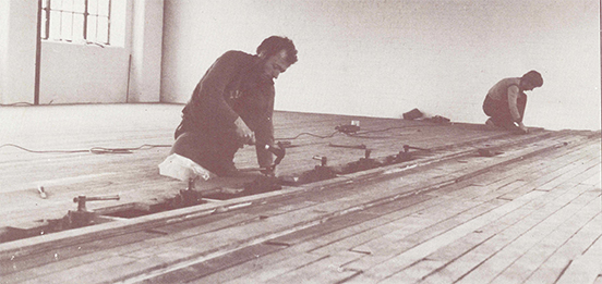 An old image of workmen working on the dance floor at Chisenhale Dance Space