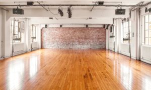 The performance studio, with shiny wooden floors and exposed brick wall